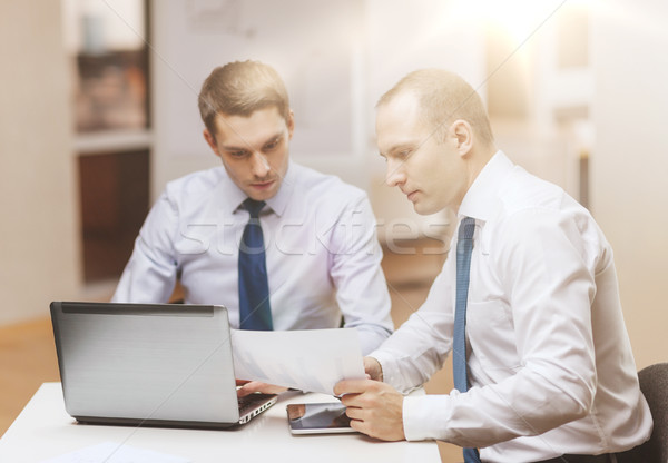 Stock photo: two businessmen having discussion in office