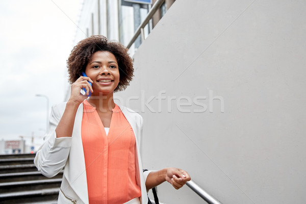 happy african businesswoman calling on smartphone Stock photo © dolgachov