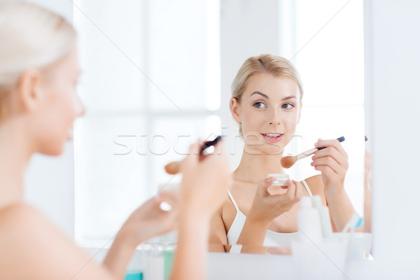 woman with makeup brush and powder at bathroom Stock photo © dolgachov