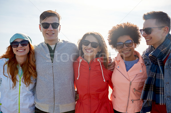 happy teenage friends in shades hugging on street Stock photo © dolgachov