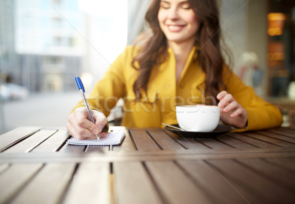 happy woman with notebook and cappucino at cafe Stock photo © dolgachov