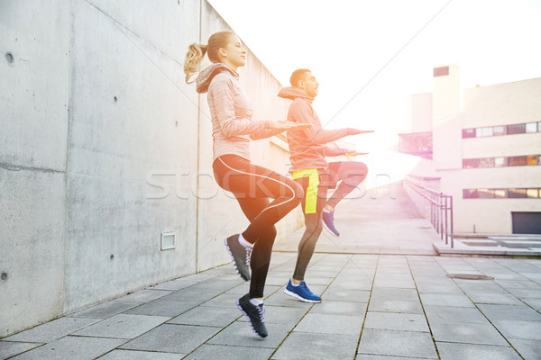 happy man and woman jumping outdoors Stock photo © dolgachov