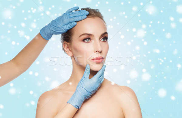 surgeon or beautician hands touching woman face Stock photo © dolgachov