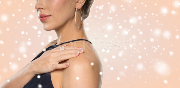 close up of beautiful woman with ring and earring Stock photo © dolgachov