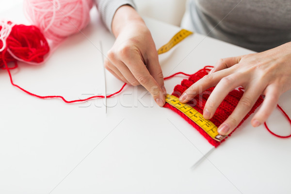 woman with knitting, needles and measuring tape Stock photo © dolgachov