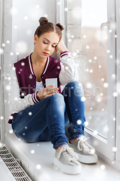 sad pretty teenage girl with smartphone texting Stock photo © dolgachov