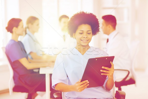 Stock photo: happy doctor over group of medics at hospital