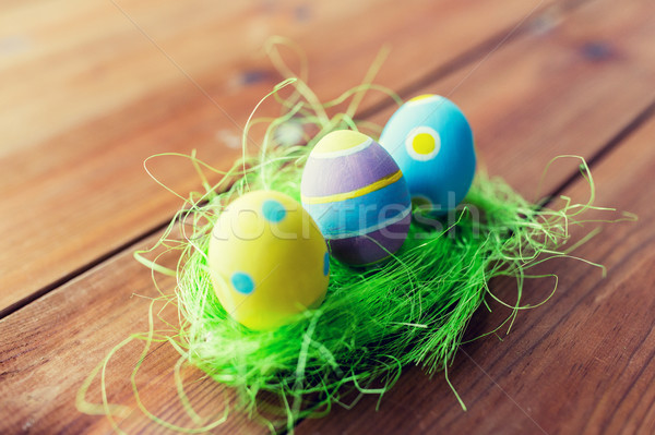 close up of colored easter eggs and grass Stock photo © dolgachov