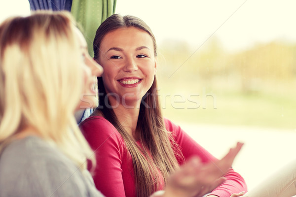 happy young women talking in travel bus or train Stock photo © dolgachov