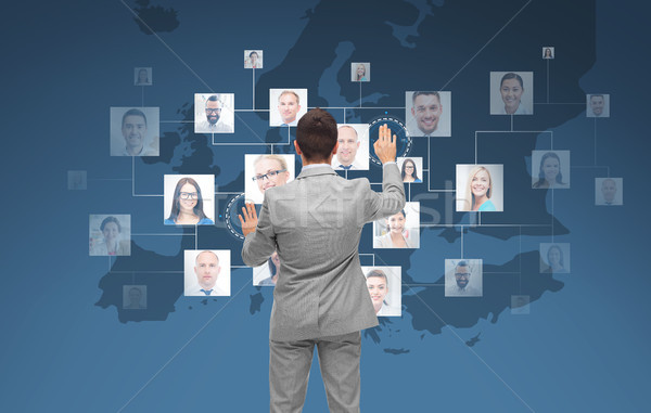 businessman using virtual screen with contacts Stock photo © dolgachov