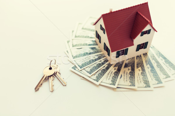 close up of home model, money and house keys Stock photo © dolgachov