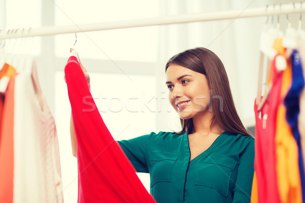 happy woman choosing clothes at home wardrobe Stock photo © dolgachov