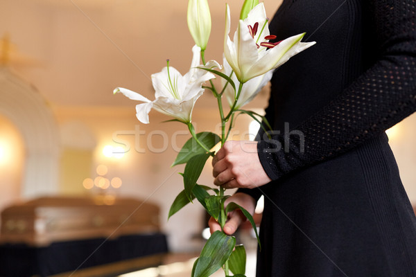 close up of woman with lily flowers at funeral Stock photo © dolgachov