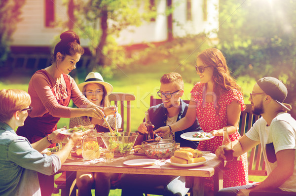 happy friends having dinner at summer garden party Stock photo © dolgachov