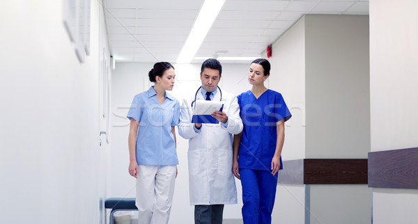 group of medics at hospital with clipboard Stock photo © dolgachov