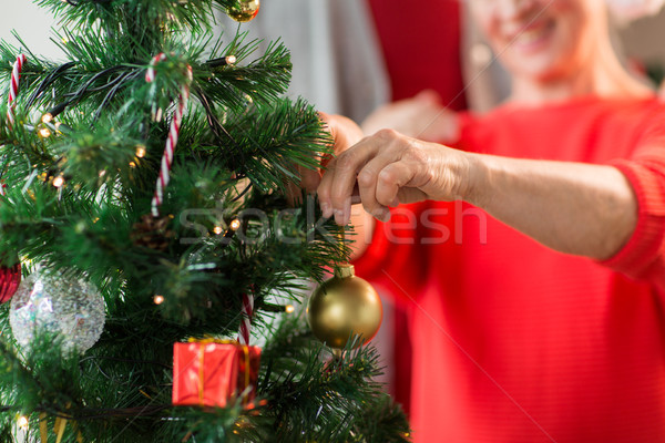 close up of senior woman decorating christmas tree Stock photo © dolgachov