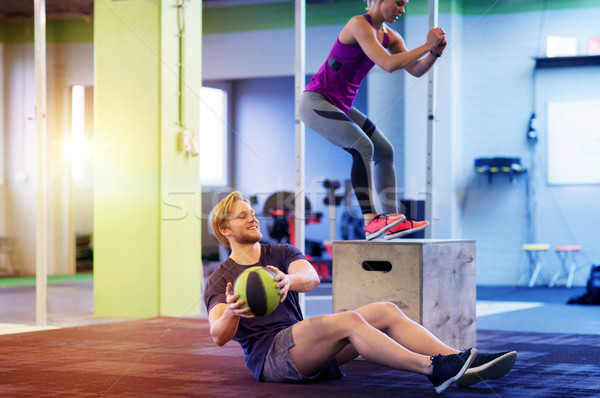 Stock photo: woman and man with medicine ball exercising in gym