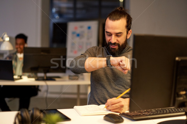 man with smartwatch using voice recorder at office Stock photo © dolgachov