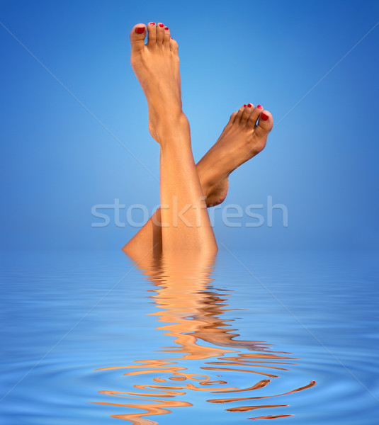 legs in blue water Stock photo © dolgachov