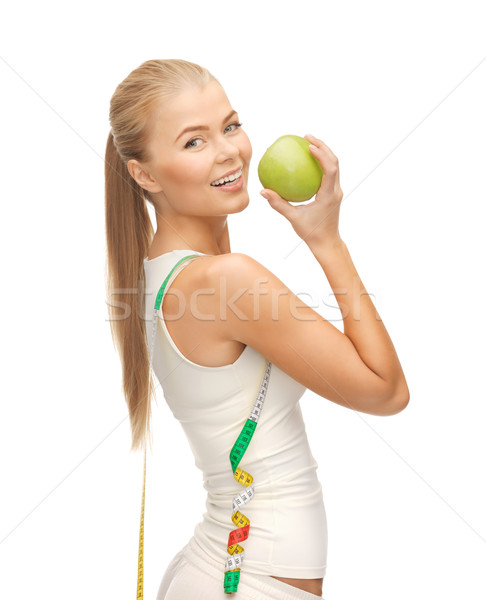 Stock photo: sporty woman with apple and measuring tape
