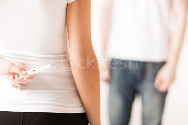 Donna nascondere test di gravidanza mani baby Foto d'archivio © dolgachov
