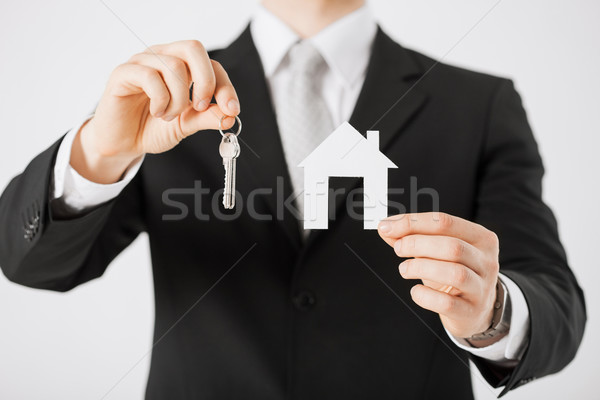 man holding house keys and paper house Stock photo © dolgachov