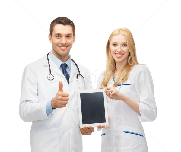 young doctors holding tablet pc in hands Stock photo © dolgachov