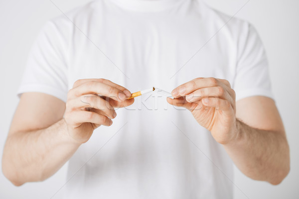 man breaking the cigarette with hands Stock photo © dolgachov