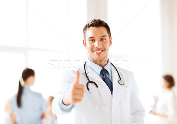 doctor with stethoscope showing thumbs up Stock photo © dolgachov