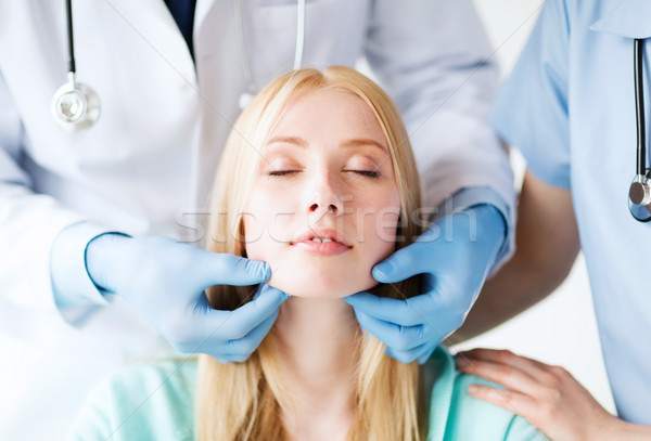 plastic surgeon or doctor with patient Stock photo © dolgachov