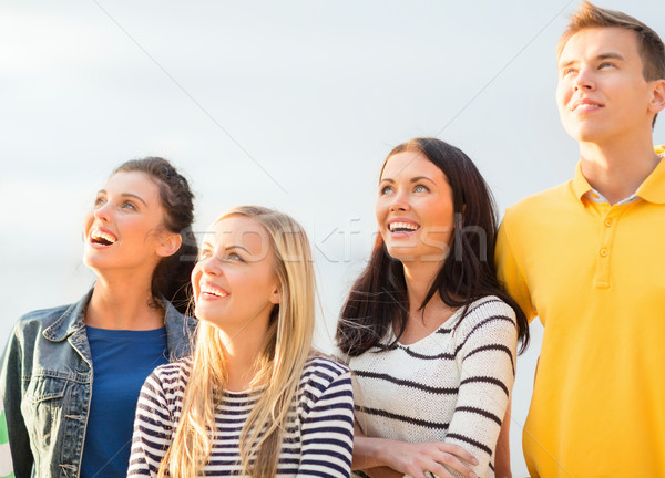 group of friends looking up on the beach Stock photo © dolgachov