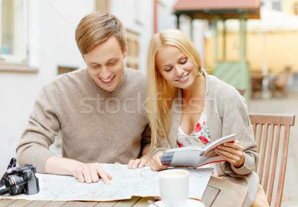 couple with map, camera, city guide and coffee Stock photo © dolgachov