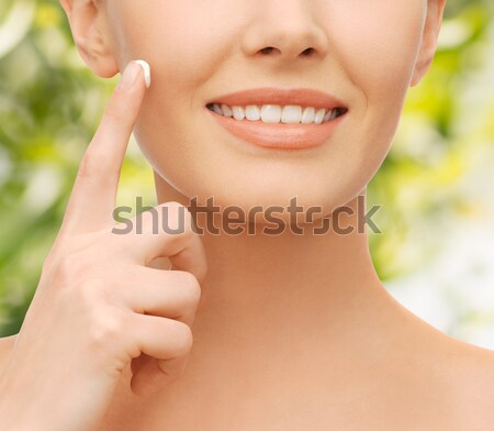 beautiful woman applying moisturizing cream Stock photo © dolgachov