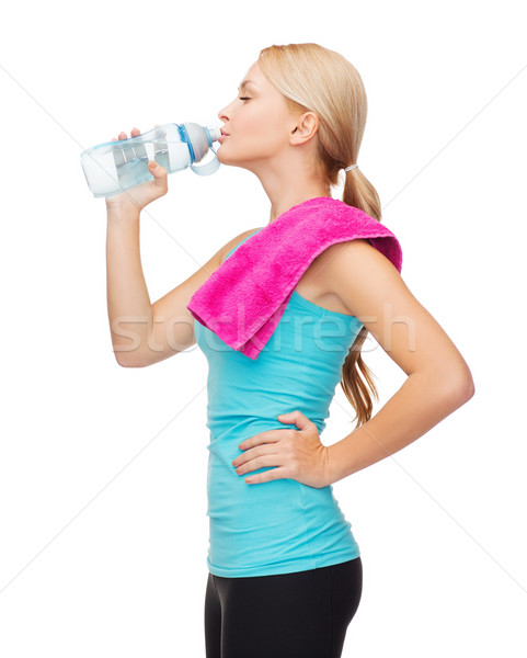 sporty woman with towel and watel bottle Stock photo © dolgachov