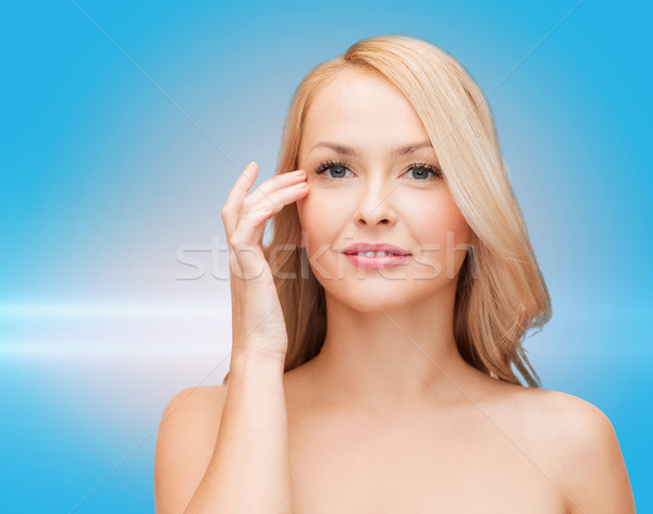 beautiful woman touching her eye area Stock photo © dolgachov
