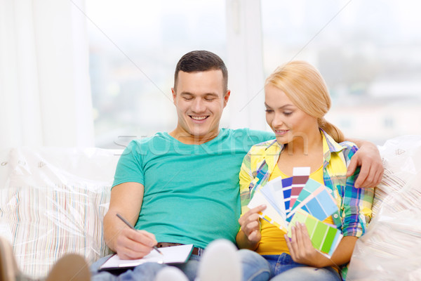 Stock photo: couple looking at color samples in new home