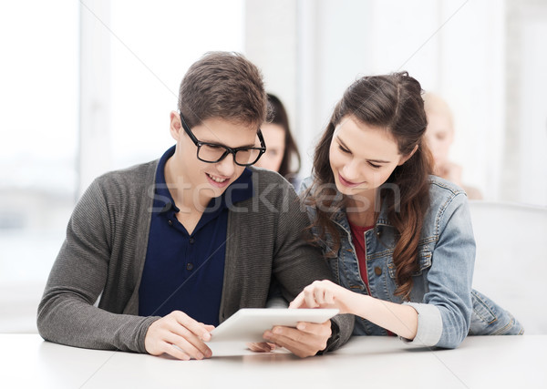 students looking at tablet pc in lecture at school Stock photo © dolgachov