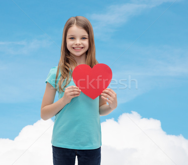smiling little girl with red heart Stock photo © dolgachov