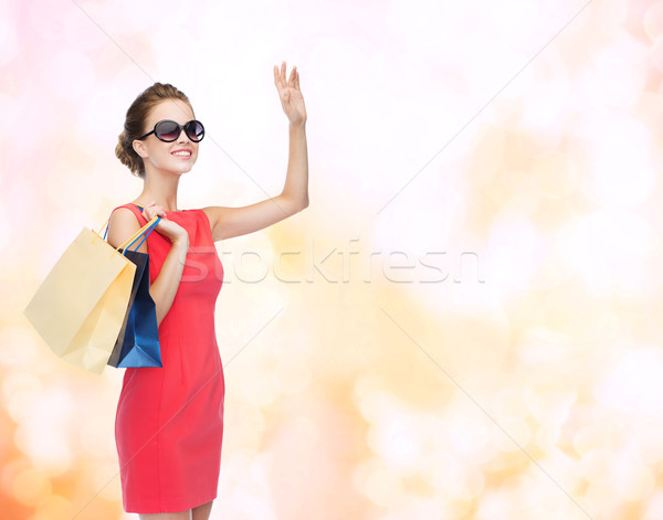 笑みを浮かべて エレガントな 女性 ドレス ショッピングバッグ ショッピング ストックフォト © dolgachov
