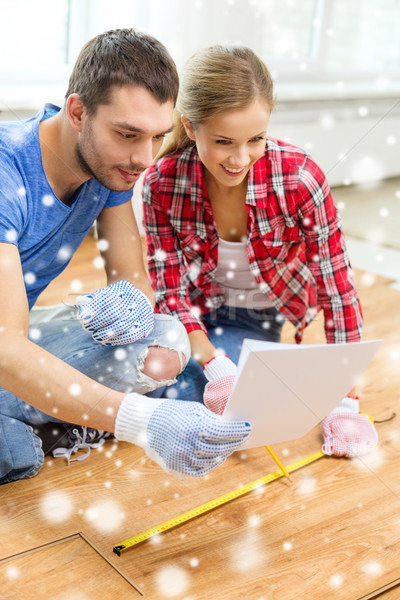 Stock photo: smiling couple measuring wood flooring