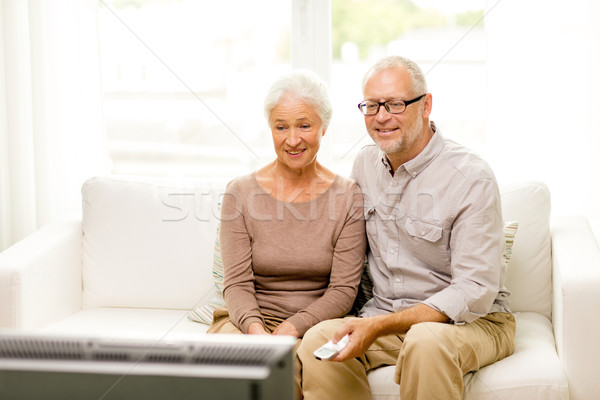 happy senior couple watching tv at home Stock photo © dolgachov