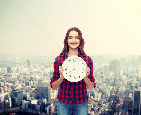 young woman in casual clothes with wall clock Stock photo © dolgachov