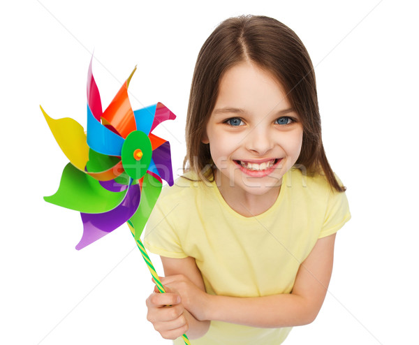 smiling child with colorful windmill toy Stock photo © dolgachov