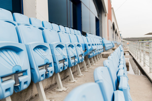 rows with folded seats of bleachers on stadium Stock photo © dolgachov