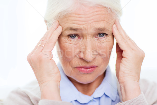 face of senior woman suffering from headache Stock photo © dolgachov