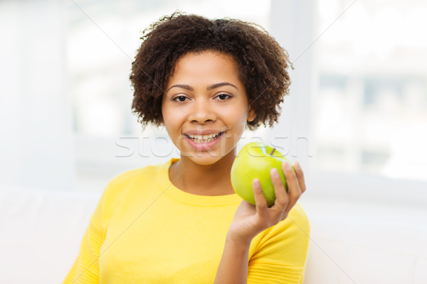 happy african american woman with green apple Stock photo © dolgachov