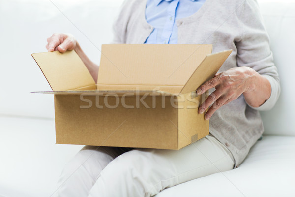 close up of senior woman with parcel box at home Stock photo © dolgachov