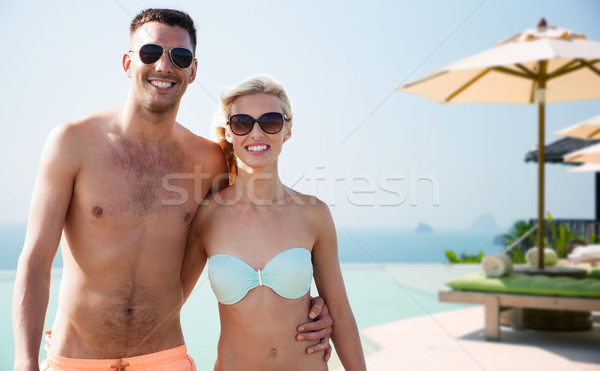 happy couple in swimwear hugging over hotel resort Stock photo © dolgachov