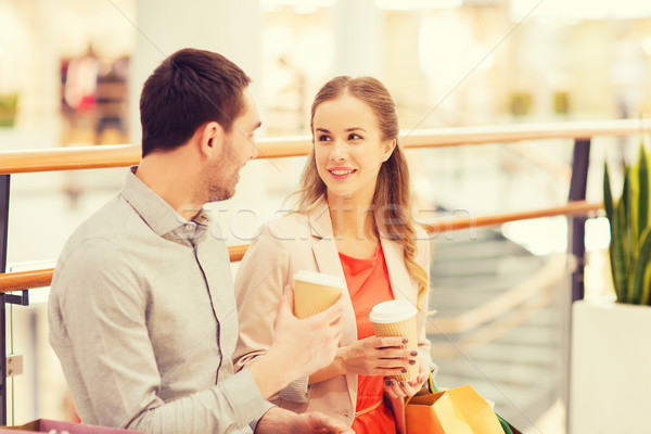 happy couple with shopping bags drinking coffee Stock photo © dolgachov