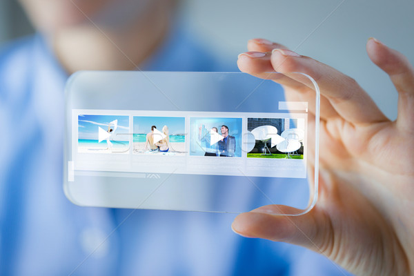 close up of woman with transparent smartphone Stock photo © dolgachov